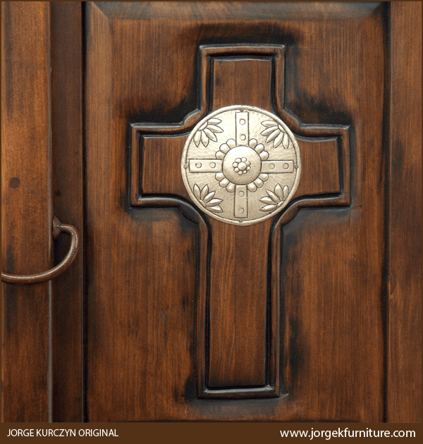 Close-up of Santa Fe armoire door panel with carved cross and silver patina copper concho