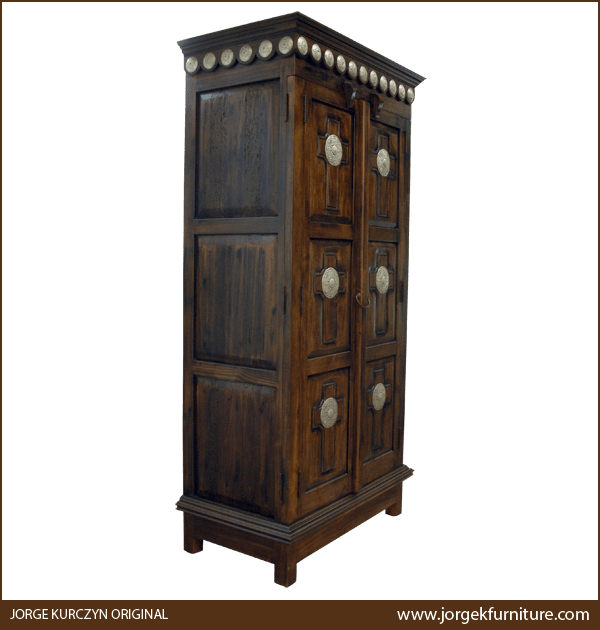 Three-quarter angle of Santa Fe armoire showing carved panels and square feet