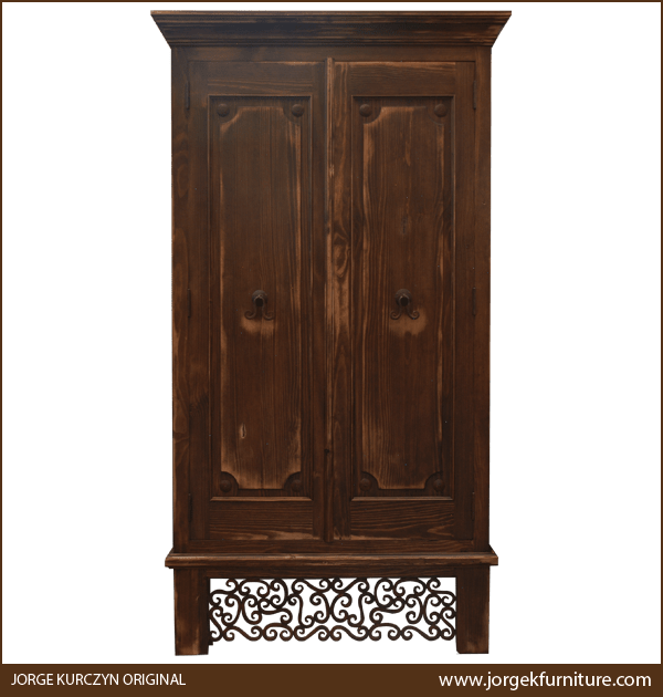 Front view of Castillo armoire with iron conchos and staggered crown molding