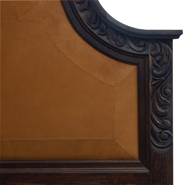 Detail of headboard with antique yellow leather and floral scroll carving on Western-style bed