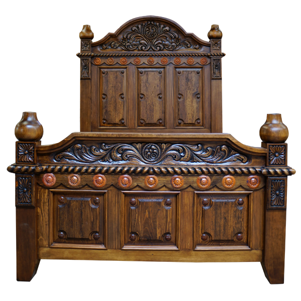 Front view of Spanish colonial bed with copper conchos and floral carving in antique finish