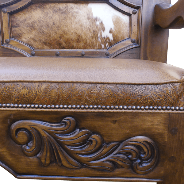 Partial front detail of footboard bench with cowhide panels and floral scroll carving