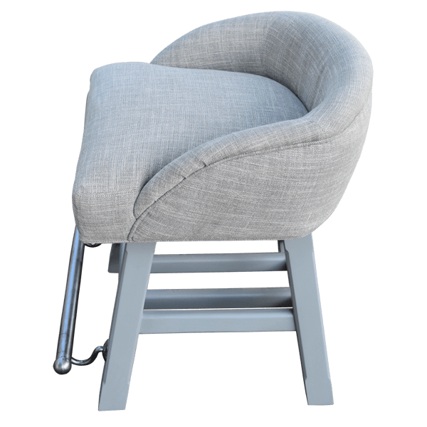 Elevated side view of handcrafted gray fabric bar stool with matching wood frame and iron footrest
